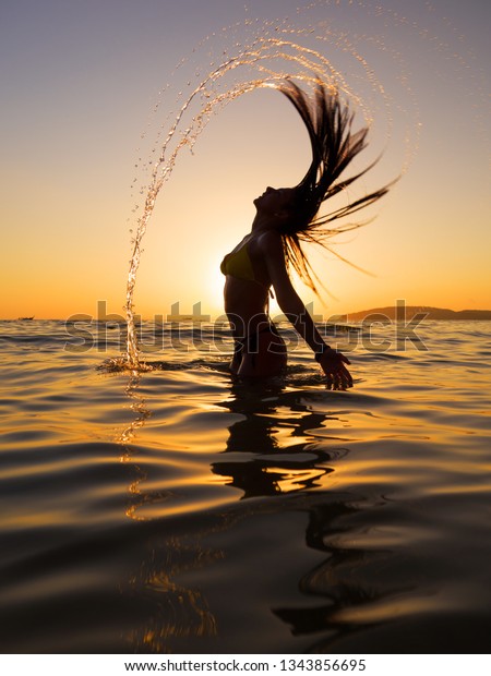 Woman Sea Sunset Flipping Her Hair Stock Photo (Edit Now) 1343856695