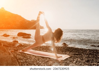 Woman sea yoga. Happy woman in white swimsuit and boho style braclets practicing outdoors on yoga mat by sea on sunset. Women yoga fitness routine. Healthy lifestyle, harmony and meditation - Shutterstock ID 2367220925