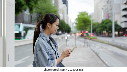 Woman Search The Bus Time Table On Cellphone In The Bus Stop In Taipei City