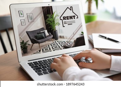 Woman Searching For Apartment On Rental Property Website Via Laptop, Closeup