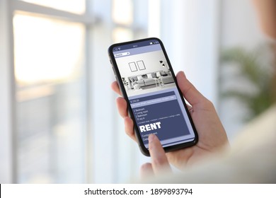 Woman Searching For Apartment On Rental Property Website Via Smartphone, Closeup