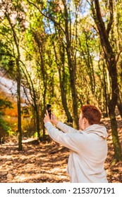 Woman Searching For Reception Signal For Her Smart Phone. Accident On Vacation. Female Lost In The Forest,