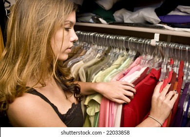 Woman searching through her closet looking for clothes