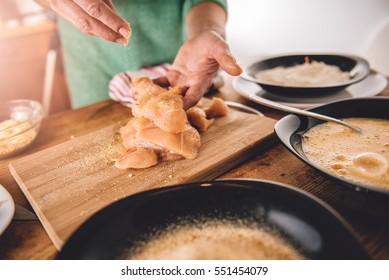 Woman Seasoning Chicken Meat