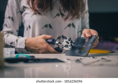 Woman Is Seen Using A Punch Tool Or Hole Maker. Craft Or Crafty Woman Using A Hole Tool To Make Holes In Rubber Material.