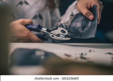 Woman Is Seen Using A Punch Tool Or Hole Maker. Craft Or Crafty Woman Using A Hole Tool To Make Holes In Rubber Material.