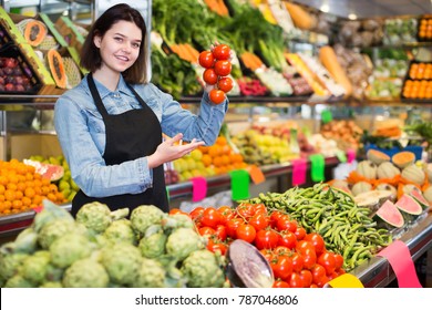 Woman seller helping customer to buy fruit and vegetables in grocery shop - Shutterstock ID 787046806