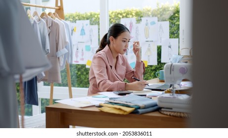 Woman seller SME retail store owner work hard worry stress in bad news on laptop at home office desk. Asian people crisis tailor job issue feel tired tough and upset in cash money loss or loan debt.