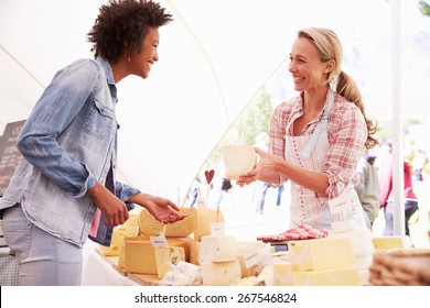 Woman Selling Fresh Cheese At Farmers Food Market