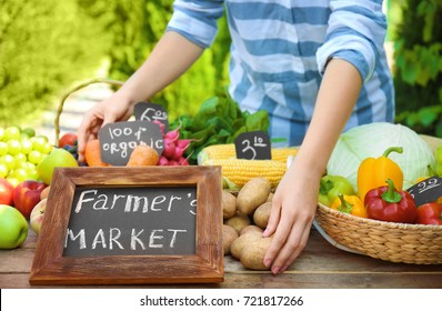 Woman Selling Fresh Fruits And Vegetables At Farmer's Market