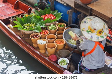 A Woman Selling Papaya Salad Bangkok Floating Market. 