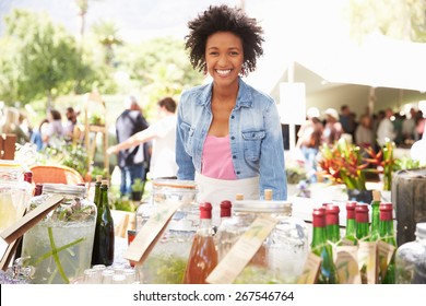 Woman Selling Soft Drinks At Farmers Market Stall