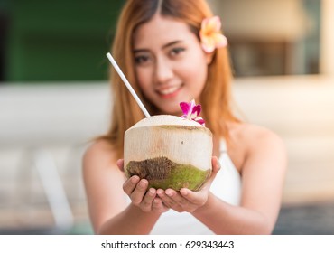 Woman send coconut in hand to you