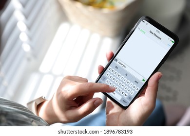 Woman sending message with text I Love You, closeup