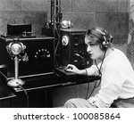 Woman sending Morse code using telegraph