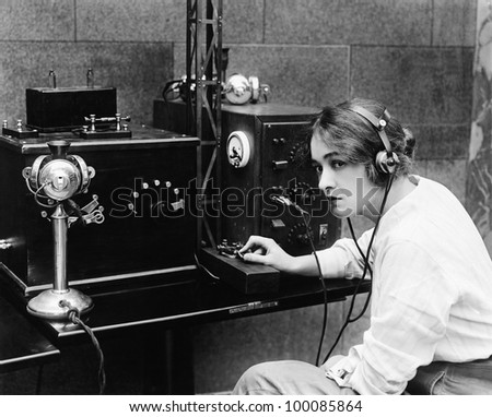 Woman sending Morse code using telegraph