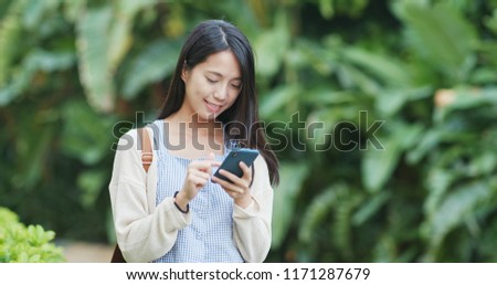 Woman sending sms on cellphone 
