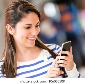 Woman Sending A Text From Her Mobile Phone