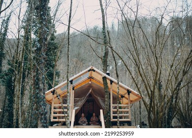 Woman Senior And Young Relaxing At Glamping Camping Tent. Women Family Elderly Mother And Young Daughter Doing Yoga And Meditation Indoor. Modern Zen-like Vacation Lifestyle Concept