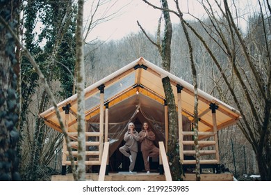 Woman Senior And Young Relaxing At Glamping Camping Tent. Women Family Elderly Mother And Young Daughter Doing Yoga And Meditation Indoor. Modern Zen-like Vacation Lifestyle Concept