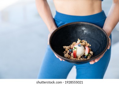 Woman Served Ice Cream Bowl With Fruit And Granola.