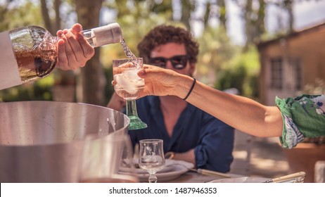 Woman Is Served Rosé Wine With Ice Cubes