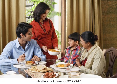 Woman Serves Dinner To Her Family