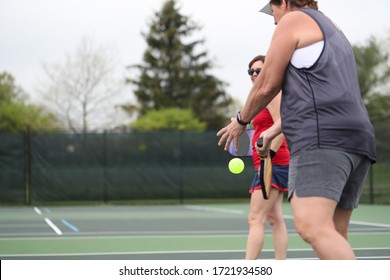 A Woman Serves During A Pickleball Doubles Match