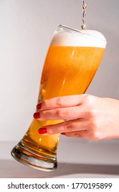 Woman Serving Beer Into Glass