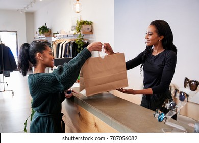 Woman Serving Customer At The Counter In A Clothing Store