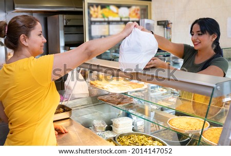 woman serving food in chicken shop, varied food