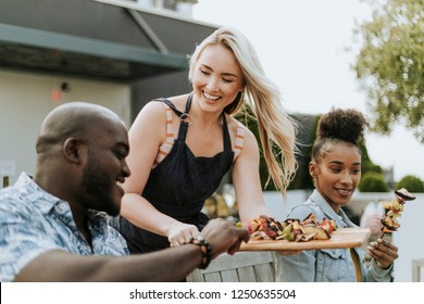 Woman Serving Her Friends Vegan Barbeque Skewers