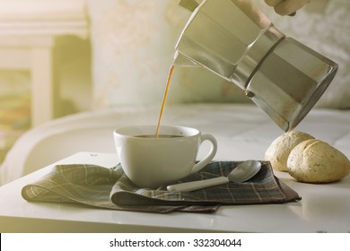 Woman Serving Hot Coffee In The Living Room Of His Home In The Morning