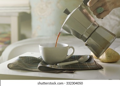 Woman Serving Hot Coffee In The Living Room Of His Home In The Morning