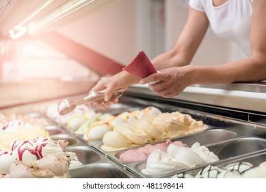 Woman Serving Ice Cream In Confectionery Shop