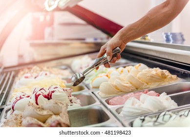 Woman Serving Ice Cream In Confectionery Shop