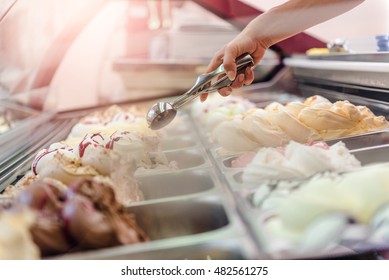 Woman serving ice cream in Confectionery shop