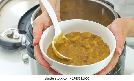 Woman Serving Soup. Multi Cooker Lentil Soup Recipe