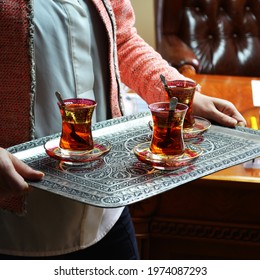 Woman Serving Turkish Tea In Traditional Hand Carved Copper Tray. Authentic Gifts And Arts Of Turkey, Istanbul Grand Bazaar Souvenirs. Hand Crafted Middle East Food Serving Style.