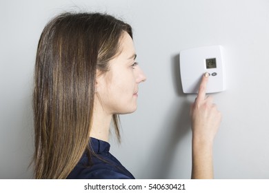 A Woman Set The Thermostat At Home