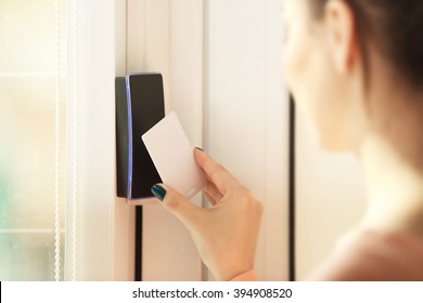 Woman Setting Control Panel On Security System At Home