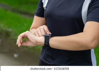 Woman Setting Up Fitness Smart Watch For Running. Female Runner Checking Heartrate Pulse On Smart Watch Device