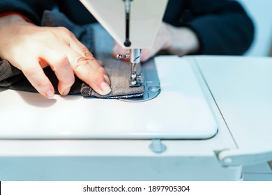 Woman Sewing The Bottom Of The Pants With Her Sewing Machine