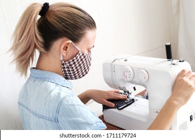 Woman Sewing Cloth Cotton Face Mask To Protect Against The Corona Virus At Home. Homemade Handicraft Protective Mask Against Covid 19 Virus.Reusable Face Mask.