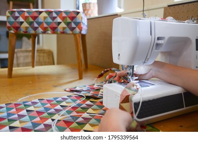 
Woman Sewing Colorful Fabric On A Sewing Machine. Upholstery Worker Sewing Upholstery Fabric. Woman Hands Working.