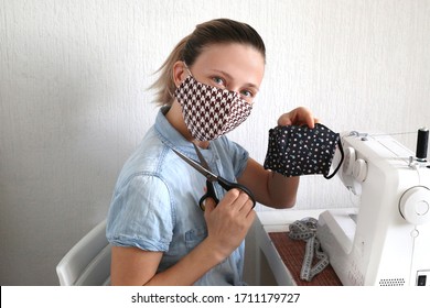 Woman Sewing Face Masks To Protect Against The Corona Virus At Home. Homemade Handicraft Protective Mask Against Covid 19 Virus.
