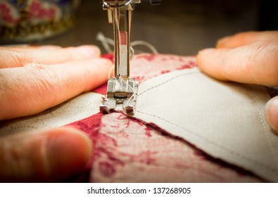 Woman At A Sewing Machine Closeup With Patchwork Tiles