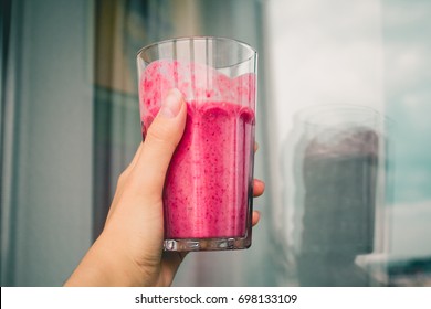 Woman Or Shake Hand With Drinking Pink Healthy Berry Smoothie Concept On Wall Background. Vegetarian Or Healthy Food From Raspberry. Close Up Or Side View.