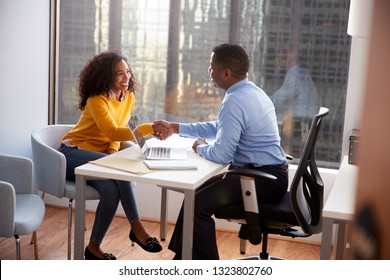 Woman Shaking Hands At Meeting With Male Financial Advisor Relationship Counsellor In Office