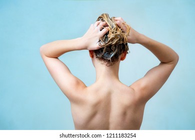 Woman Shampooing Her Hair And Taking Shower On Blue Background